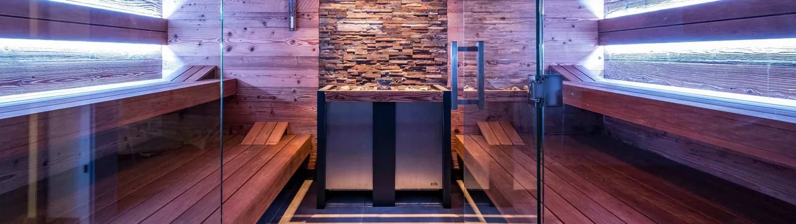 EOS-equipped home sauna with warm wood benches, a glass front and a large window
