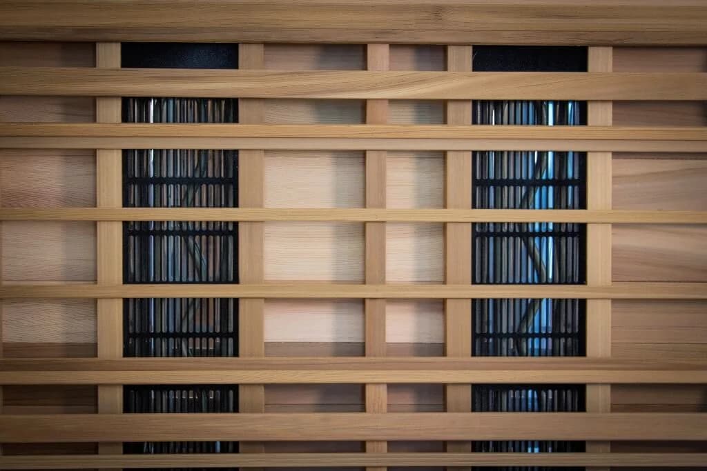 Close-up of Health Mate Enrich 2 Tecoloy carbon heater panels behind cedar slats