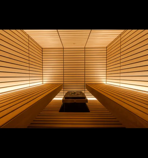 Sentiotec sauna interior with backlit wood slats and a bench