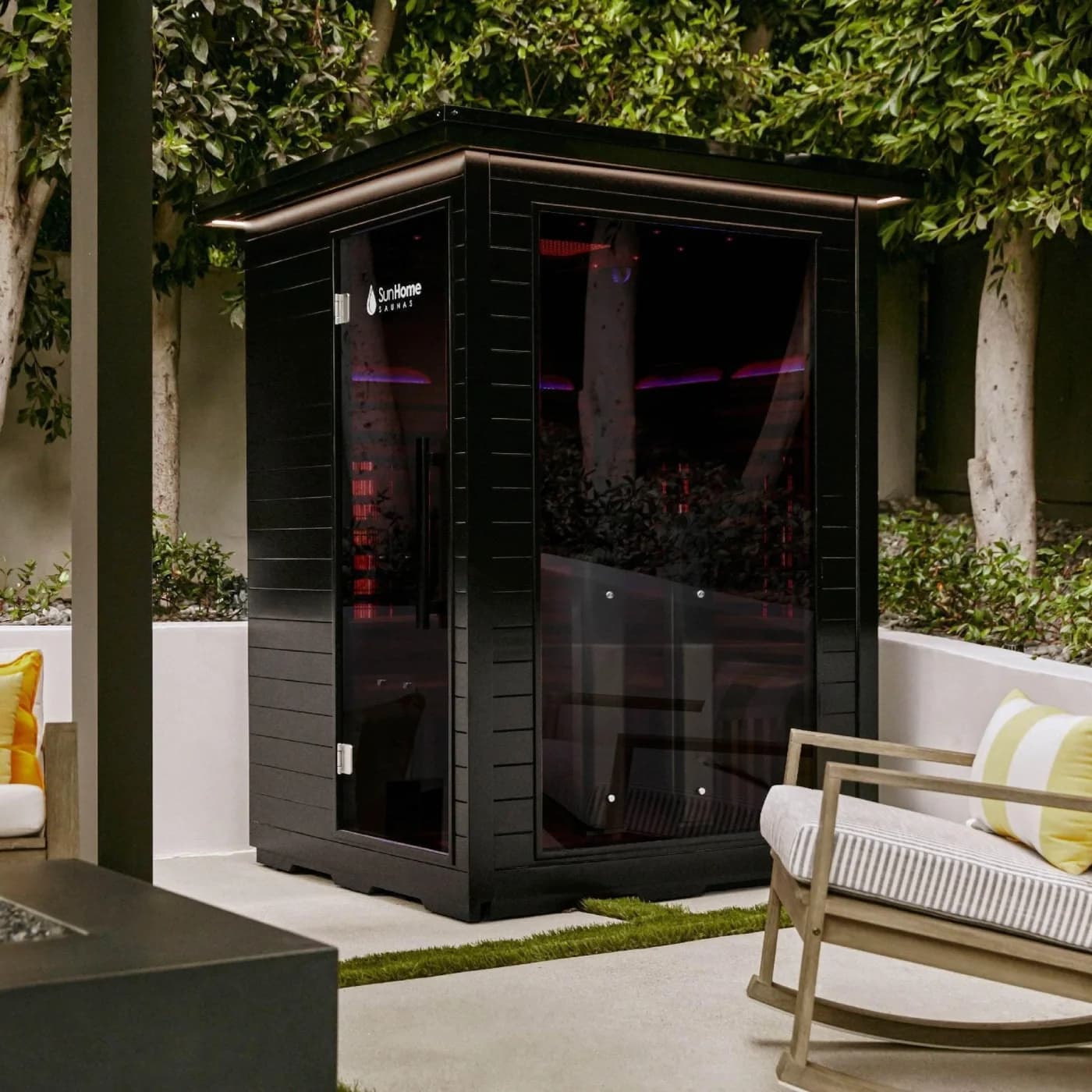 Sun Home Luminar outdoor infrared sauna on a patio at night