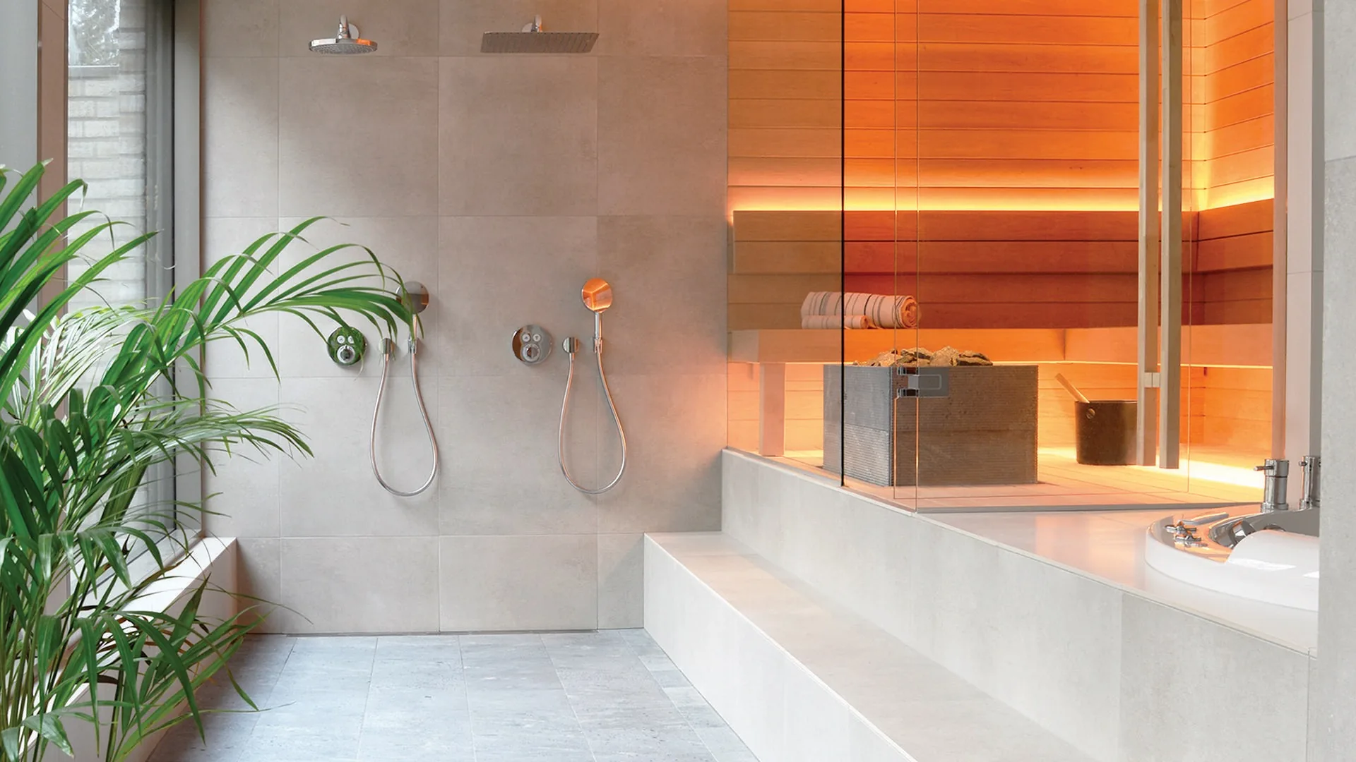 Tulikivi Tuisku XL soapstone heater in a modern sauna next to a tiled wet room with rain shower