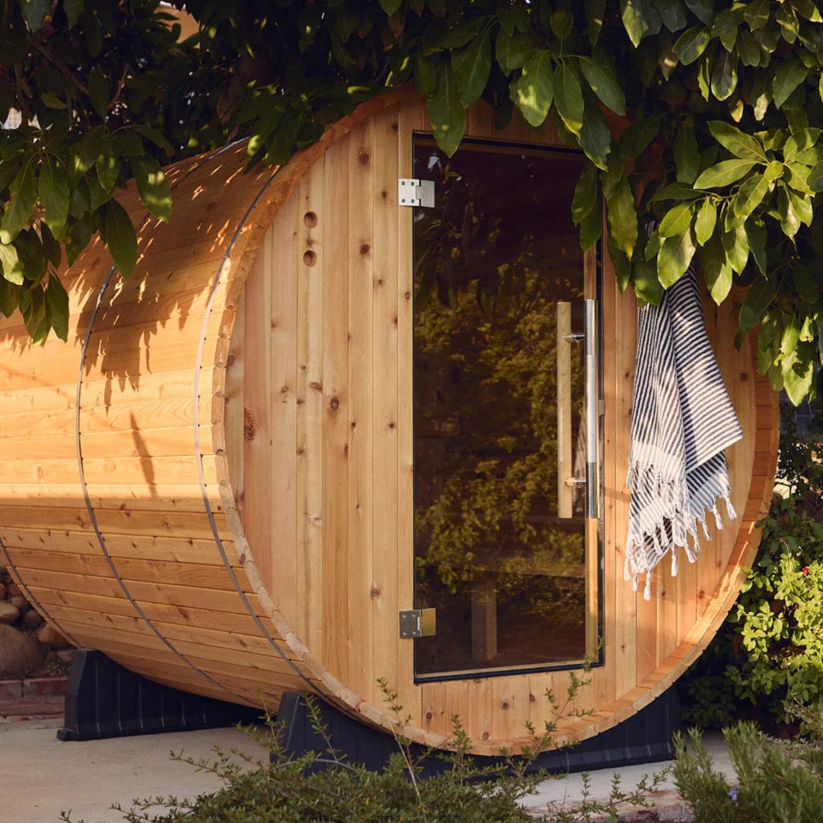 Almost Heaven Pinnacle 4-person barrel sauna installed in a backyard
