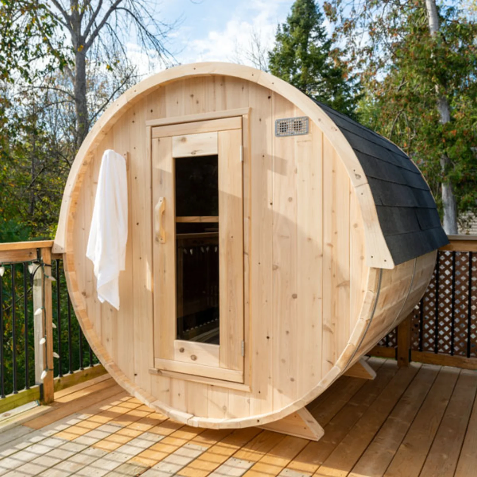 Interior of Dundalk cedar barrel sauna showing curved benches and stove heater