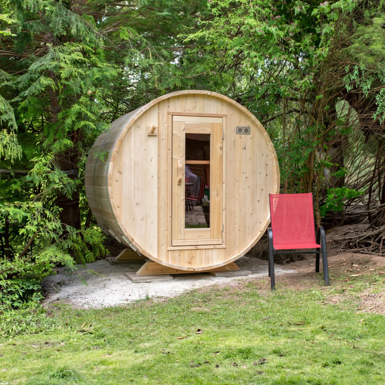 Dundalk Canadian Timber cedar barrel sauna with steel band hoops outdoors